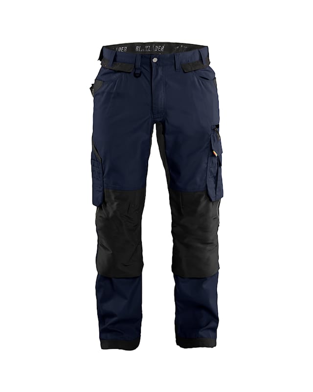 Navy and black work pants with multiple pockets on a white background