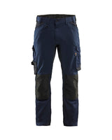 Navy blue work pants with black knee pads on a white background
