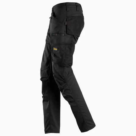 Side view of women's flexible cargo work pants showing the ergonomic pre-bent knees and slim fit design.