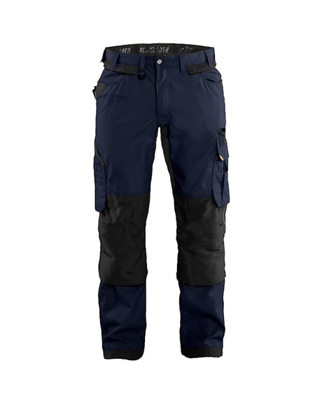 Navy and black work pants with multiple pockets on a white background