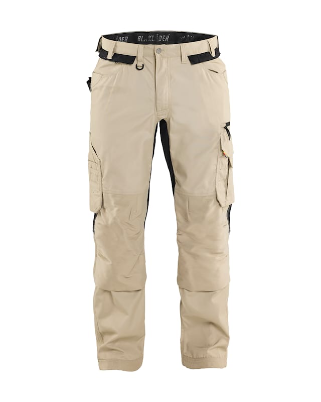 Beige cargo pants with black accents on a white background