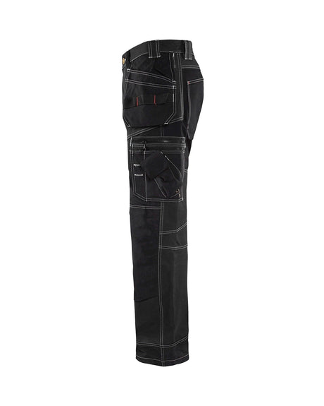 Side view of Blaklader X1600 pants showing the CORDURA reinforced ruler pocket, hammer loop, and adjustable ankle hems.